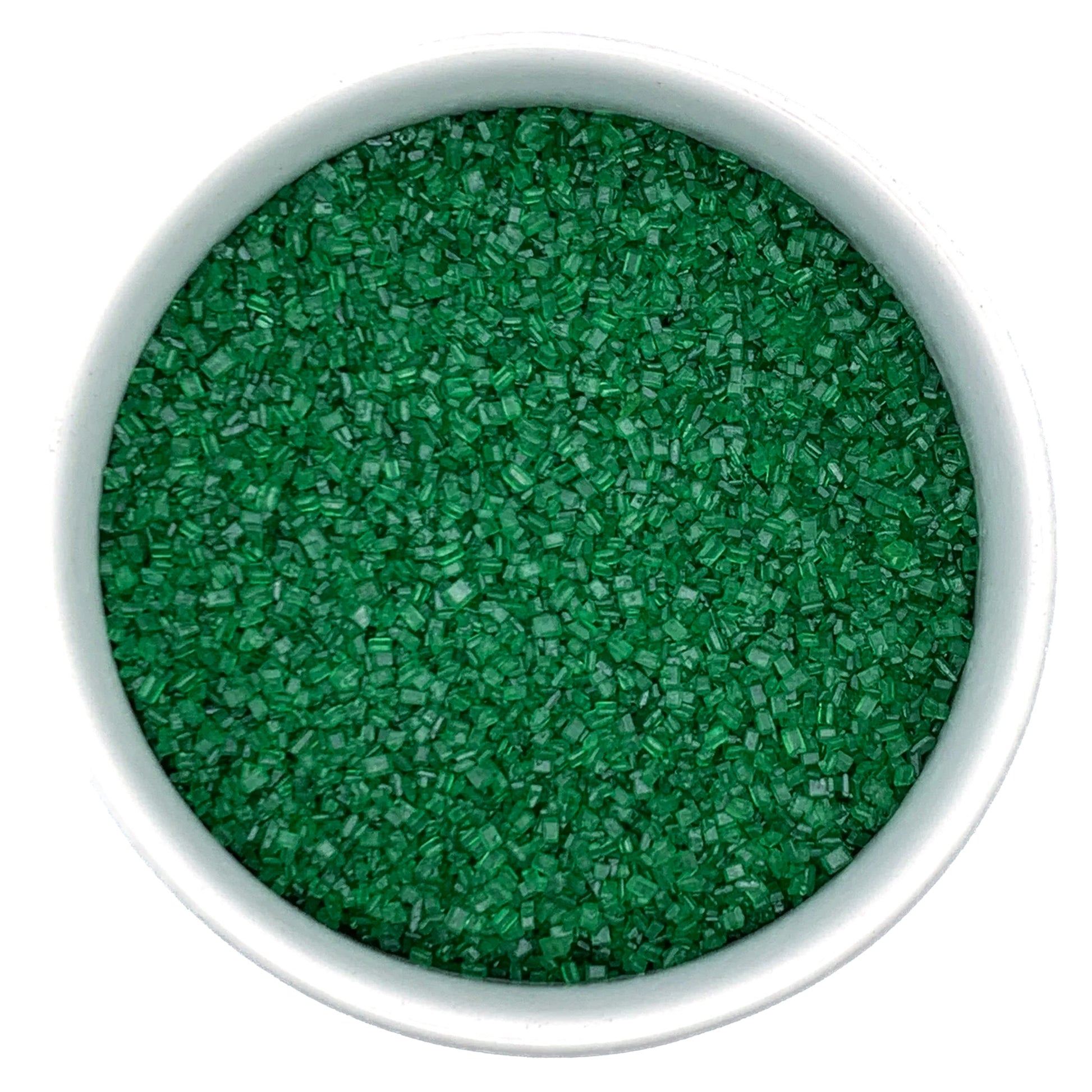Green sanding sugar crystals in a white bowl for cake and cookie decorating.