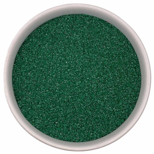 Top-down view of a white bowl filled with deep green fine sanding sugar crystals, tightly packed with a subtle sparkle.