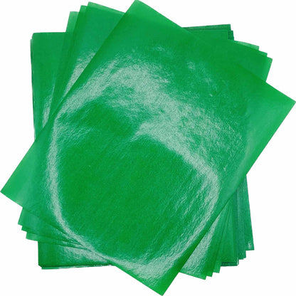 Overlapping stack of bright green 4" x 5" wax caramel wrappers with a smooth, lightly glossy surface.