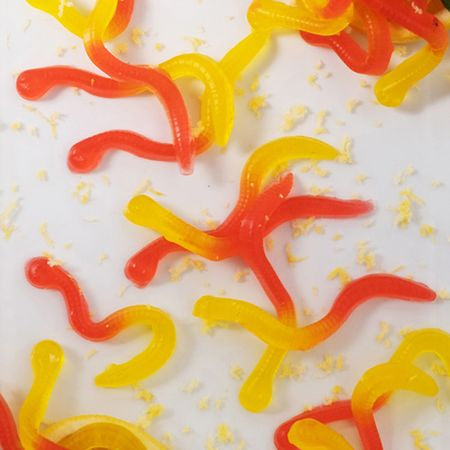 Red and yellow gummy worms evenly coated and separated, demonstrating the anti-stick effect of LorAnn's Finishing Coating.