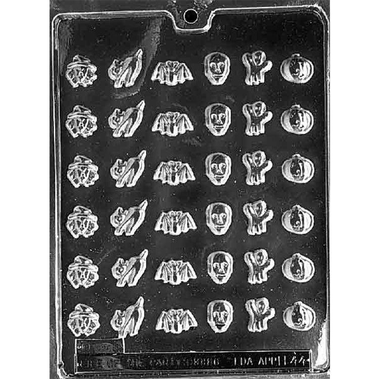 Clear plastic chocolate mold tray with small Halloween shapes including witch head, cat, bat, skull, ghost, and jack-o’-lantern cavities.