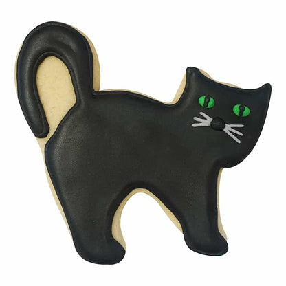 Black cat-shaped cookie with sleek icing, green eyes, and delicate white whiskers.