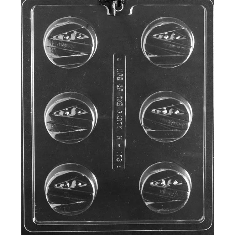 Chocolate covered Oreo mold with six round cavities, each featuring a wrapped mummy face design with visible eyes for Halloween-themed cookies and chocolates