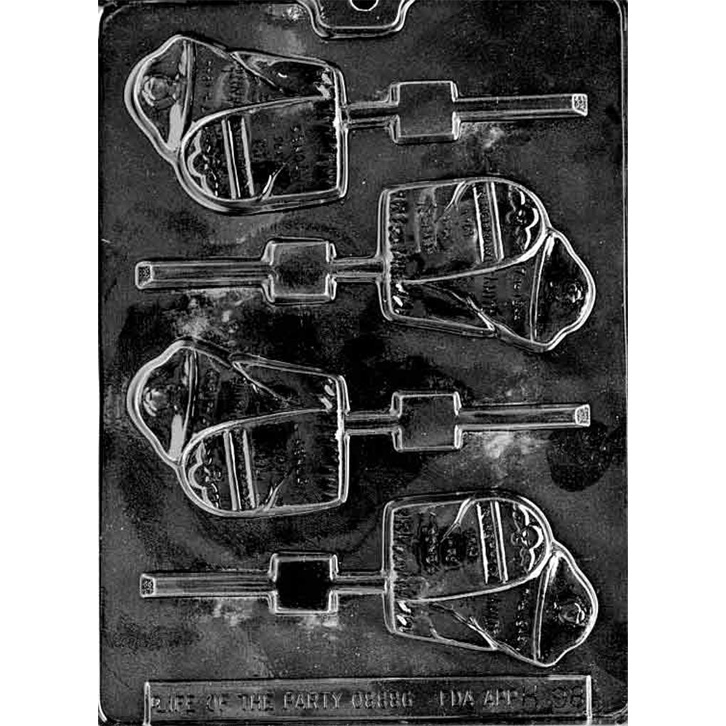 Clear plastic chocolate lollipop mold with four gravestone-shaped cavities and stick channels, photographed on a dark background for Halloween candy making.