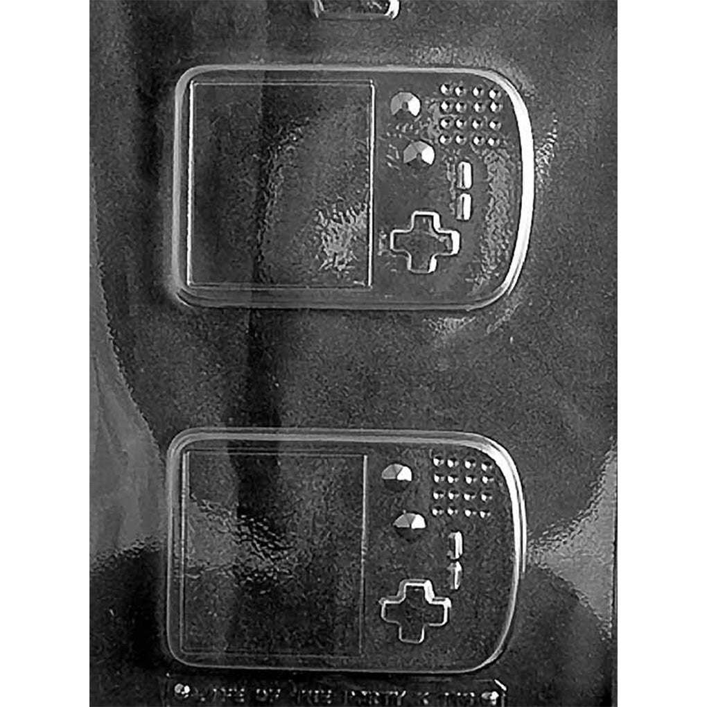 Clear Game Toy Chocolate Mold photographed against a black background with one large handheld video game device cavity featuring a raised screen, directional controls, and buttons.