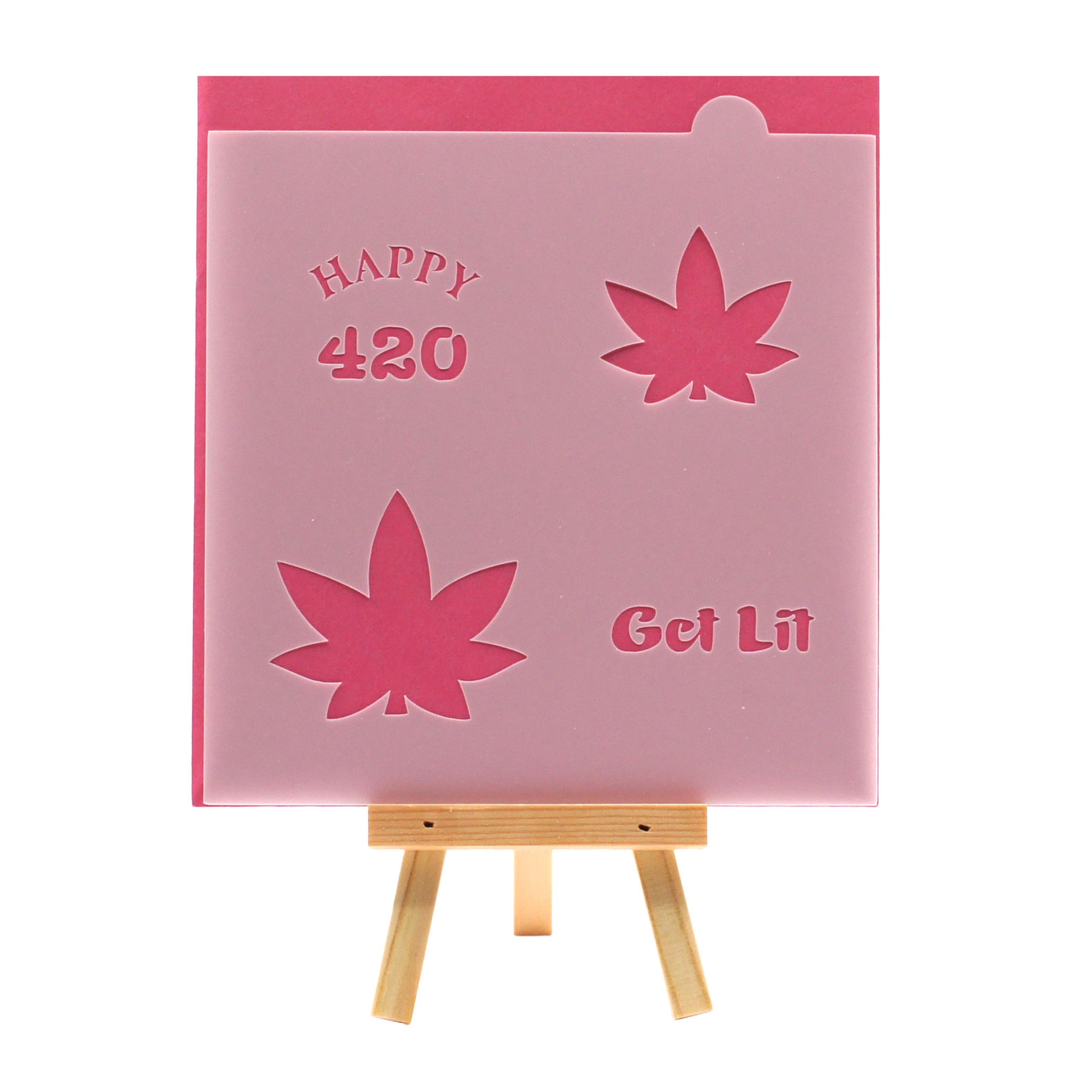 Cookie stencil with “Happy 420,” “Get Lit,” and two marijuana leaf cutouts, shown on a pink background with a small wooden easel.