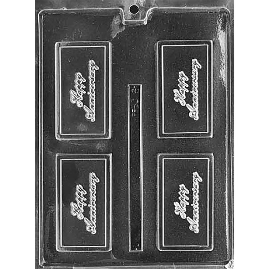 Clear plastic chocolate bar mold photographed on a black background, featuring four rectangular cavities embossed with “Happy Anniversary” script inside a raised bordered frame.
