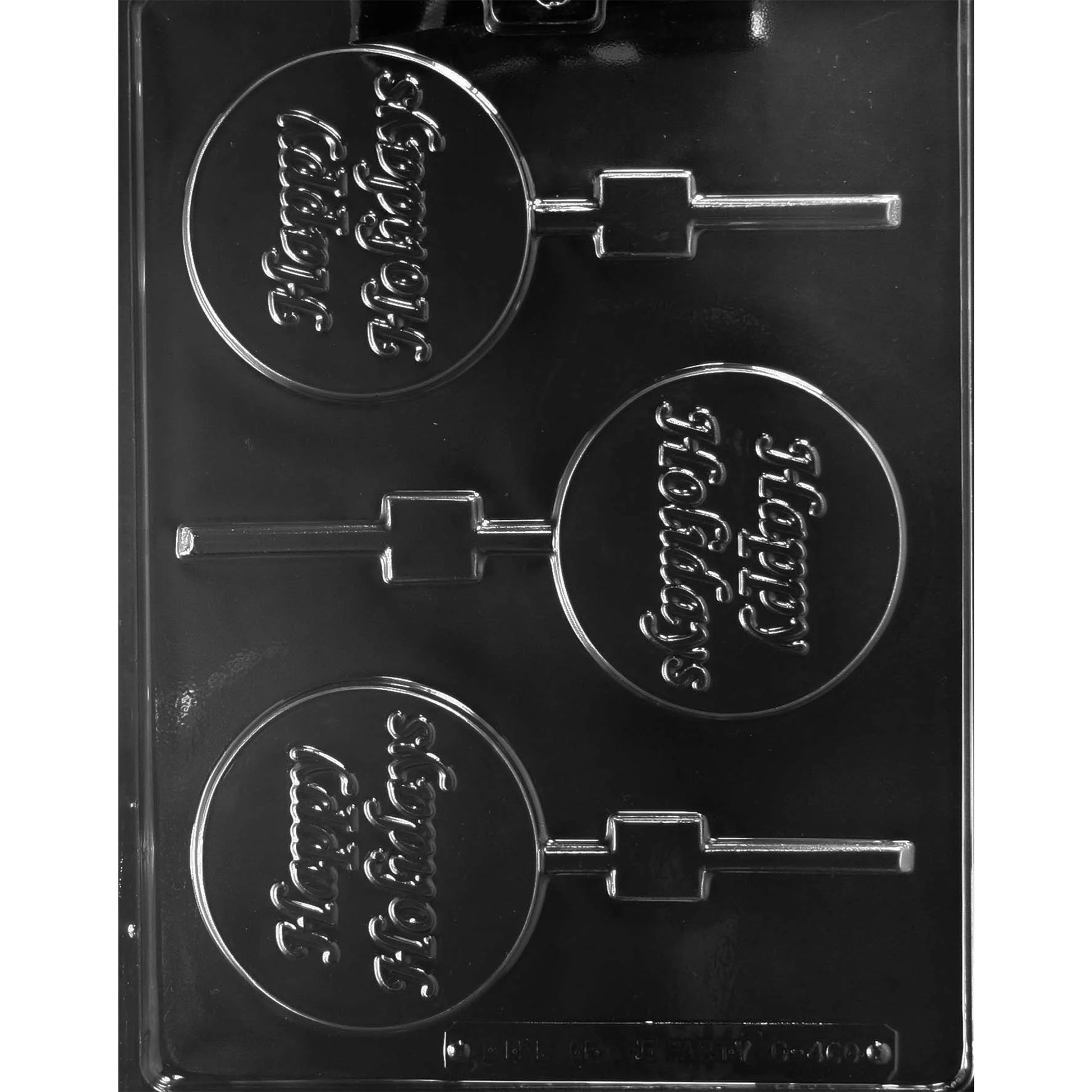 Clear plastic chocolate lollipop mold with three round cavities embossed with the words “Happy Holidays,” each with a stick channel, shown on a dark background.