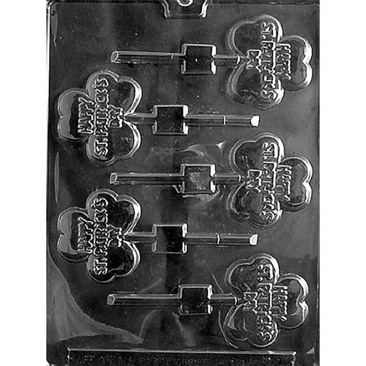 Happy St. Patrick’s Day clover chocolate lollipop mold with six shamrock-shaped cavities, each embossed with “Happy St. Patrick’s Day,” plus lollipop stick channels, shown in clear plastic.
