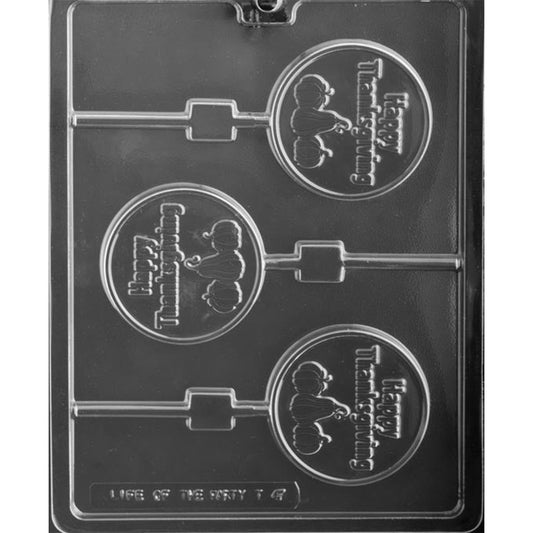 Clear chocolate lollipop mold with three round cavities featuring raised “Happy Thanksgiving” lettering above three pumpkins, each connected to a straight stick channel.
