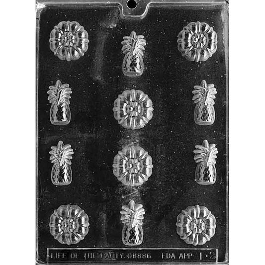 Clear Hawaii Pineapple Chocolate Mold photographed against a black background with 12 cavities featuring 6 detailed pineapples and 6 coordinating tropical flower designs.