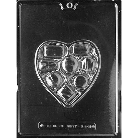 Clear plastic chocolate mold with one large heart-shaped cavity designed like an open Valentine candy box, featuring multiple small candy compartments, shown on a dark background.