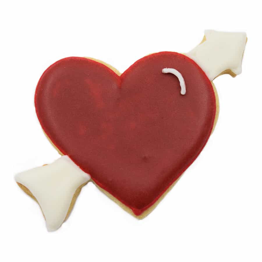 Decorated heart cookie with a red icing finish and a white arrow detail.