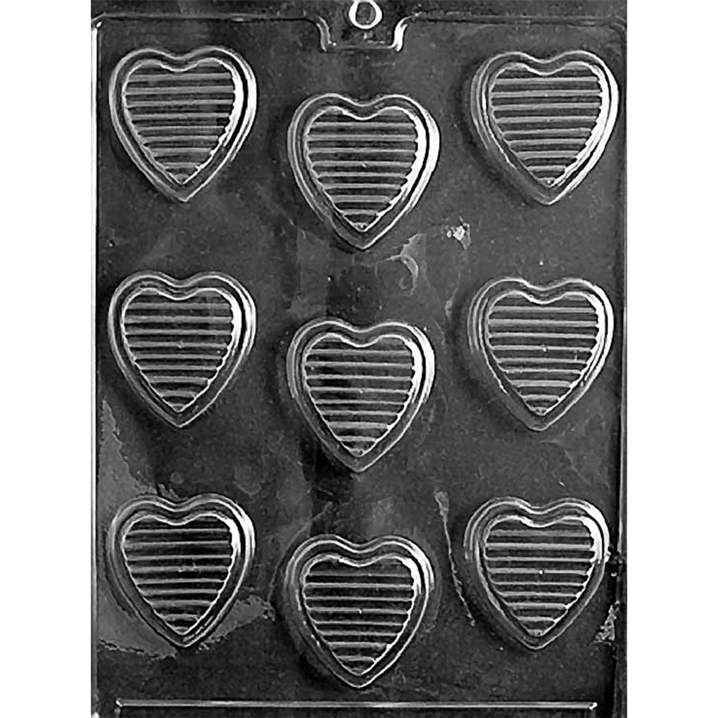 Clear Hearts with Ridges Chocolate Mold photographed against a black background with nine heart-shaped cavities featuring evenly spaced horizontal ridges.