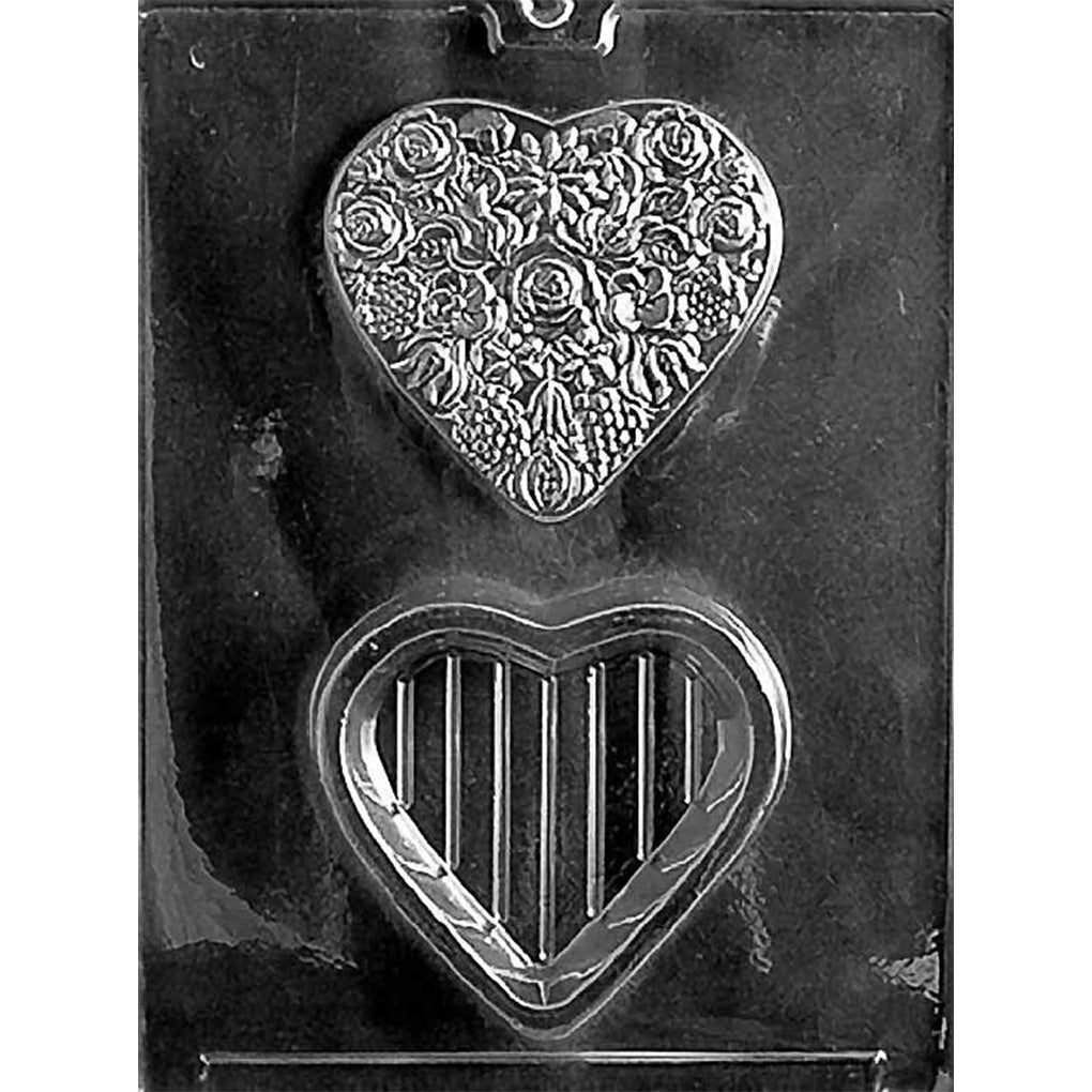 Clear Flowered Heart Pour Box Chocolate Mold photographed against a black background with a floral heart lid cavity and matching heart-shaped base cavity.