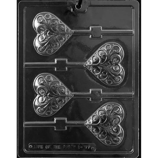 Clear Heart with Swirls Chocolate Lollipop Mold photographed against a black background with four heart-shaped cavities featuring ornate curling swirl designs and stick channels.