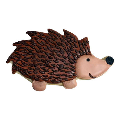 Decorated hedgehog cookie with brown icing and textured spiky details.