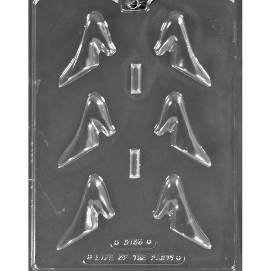 Clear plastic chocolate mold photographed on a dark background with six small high heel shoe-shaped cavities arranged in two columns, each forming a 3D pump silhouette.