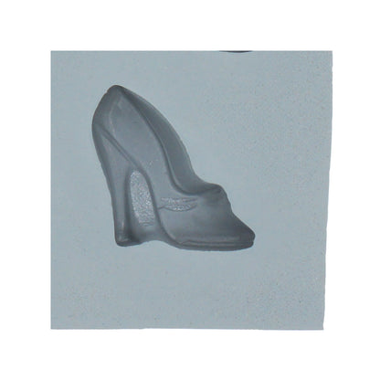 Close-up of a gray natural rubber mint mold section shaped like a high heel pump with a tall heel and small accent across the front.