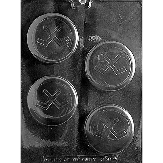 Clear plastic chocolate mold photographed on a dark background with four round hockey puck cavities, each featuring an embossed crossed hockey sticks design in the center.