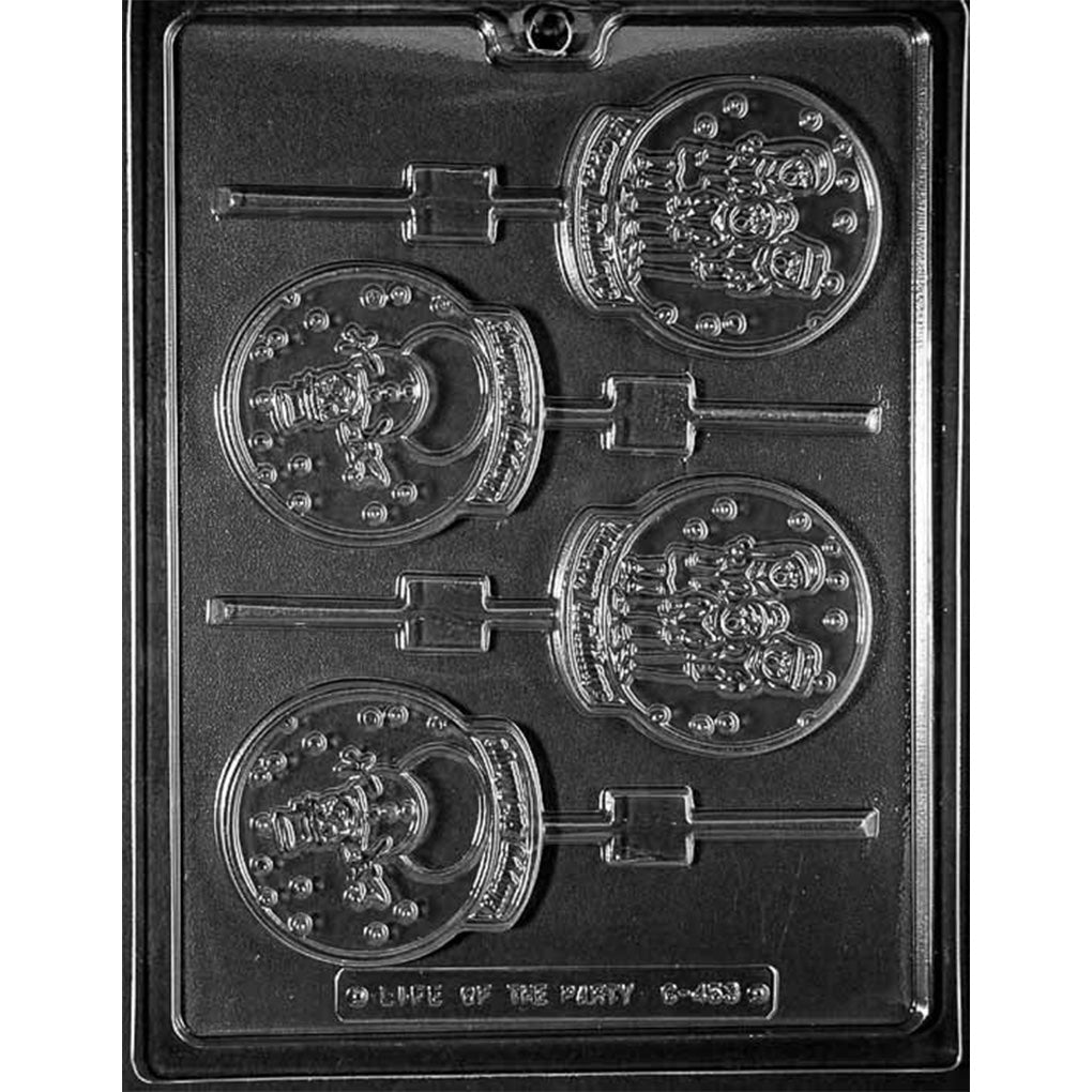 Clear plastic chocolate lollipop mold with four round snow globe-shaped cavities featuring two holiday scenes, including a snowman in a top hat and a group of three carolers, each with a built-in stick channel on a dark background.