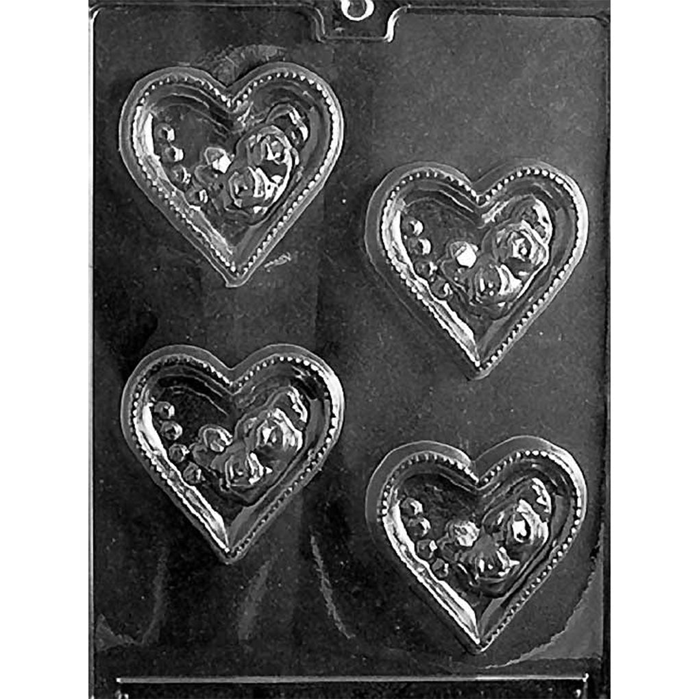 Clear Hollow Hearts With Roses Chocolate Mold photographed against a black background with four heart-shaped cavities featuring open centers, rose details, and dotted borders.