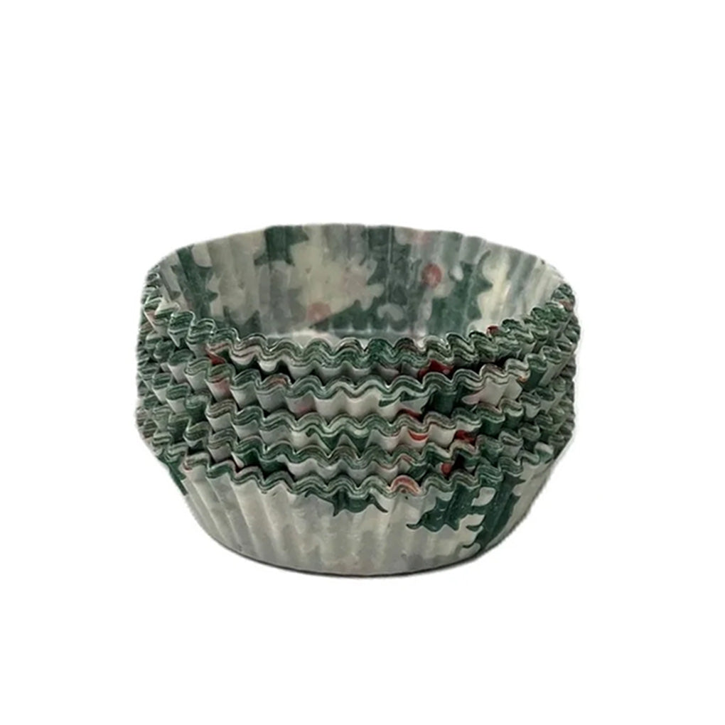 Stack of holly-patterned candy cups with green holiday print and fluted accordion sides, shown nested together on a white background.
