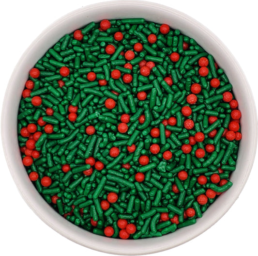 Green and red holiday sprinkle mix with jimmies and sugar pearls in a white bowl, perfect for decorating Christmas cookies and desserts.