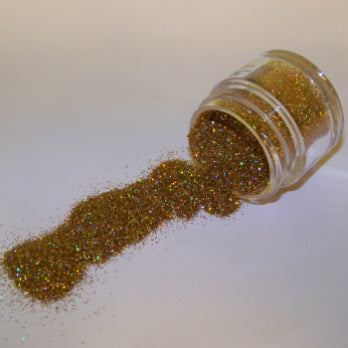 Warm gold bronze-toned Galaxy Glitter Dust flowing from a jar, featuring rich golden sparkle with hints of red and green.