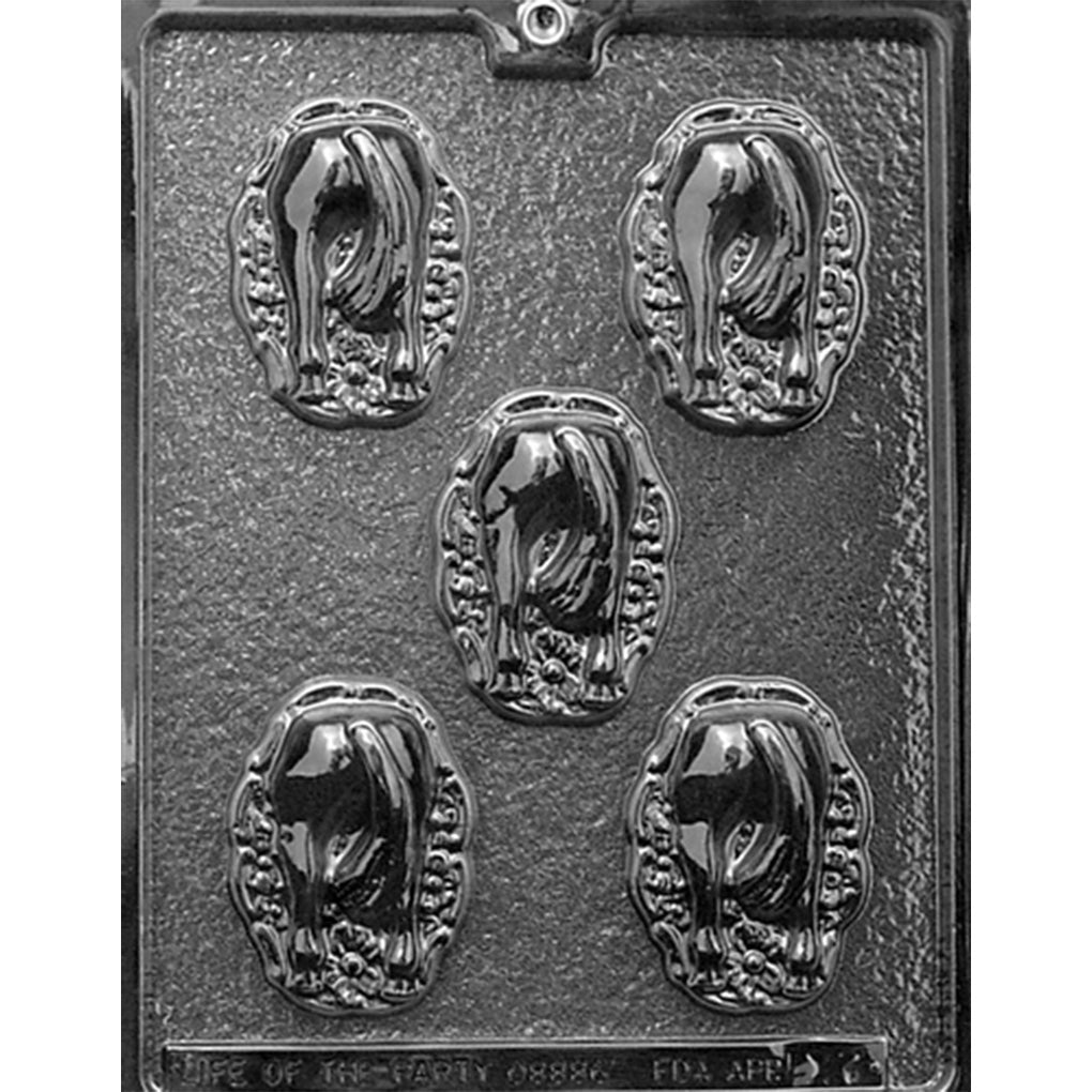 Clear Horse's Hiney in Wreath Chocolate Mold photographed against a dark background, showing five horse rear cavities framed by oval decorative wreaths with floral details.