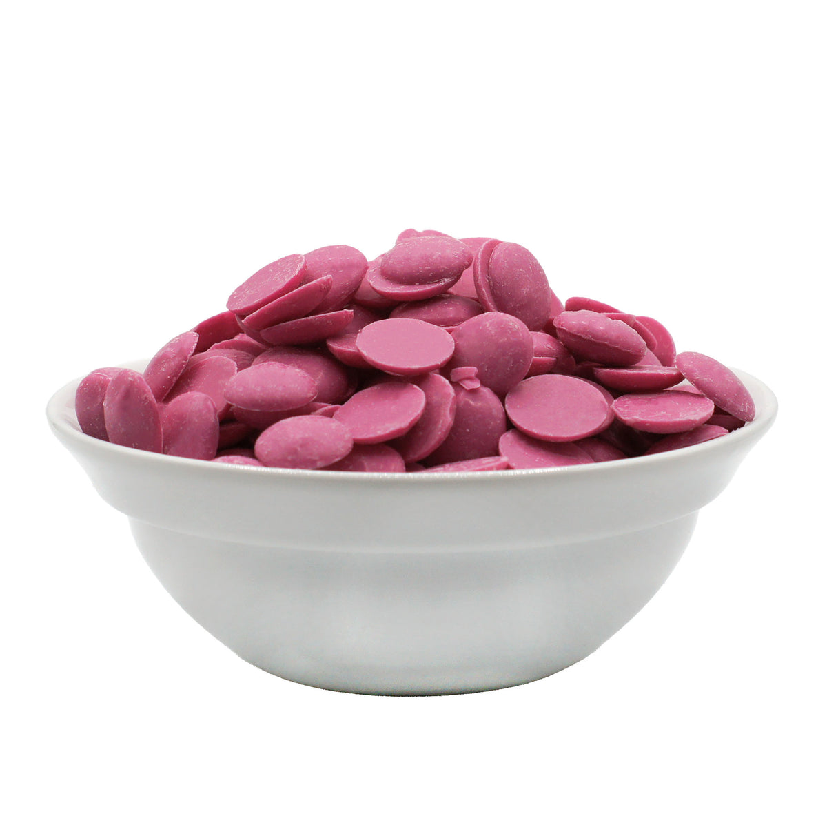 Pink candy melting wafers piled in a white bowl, side view on a white background.