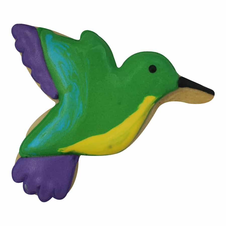 Decorated hummingbird-shaped cookie with green, yellow, purple, and black icing details.