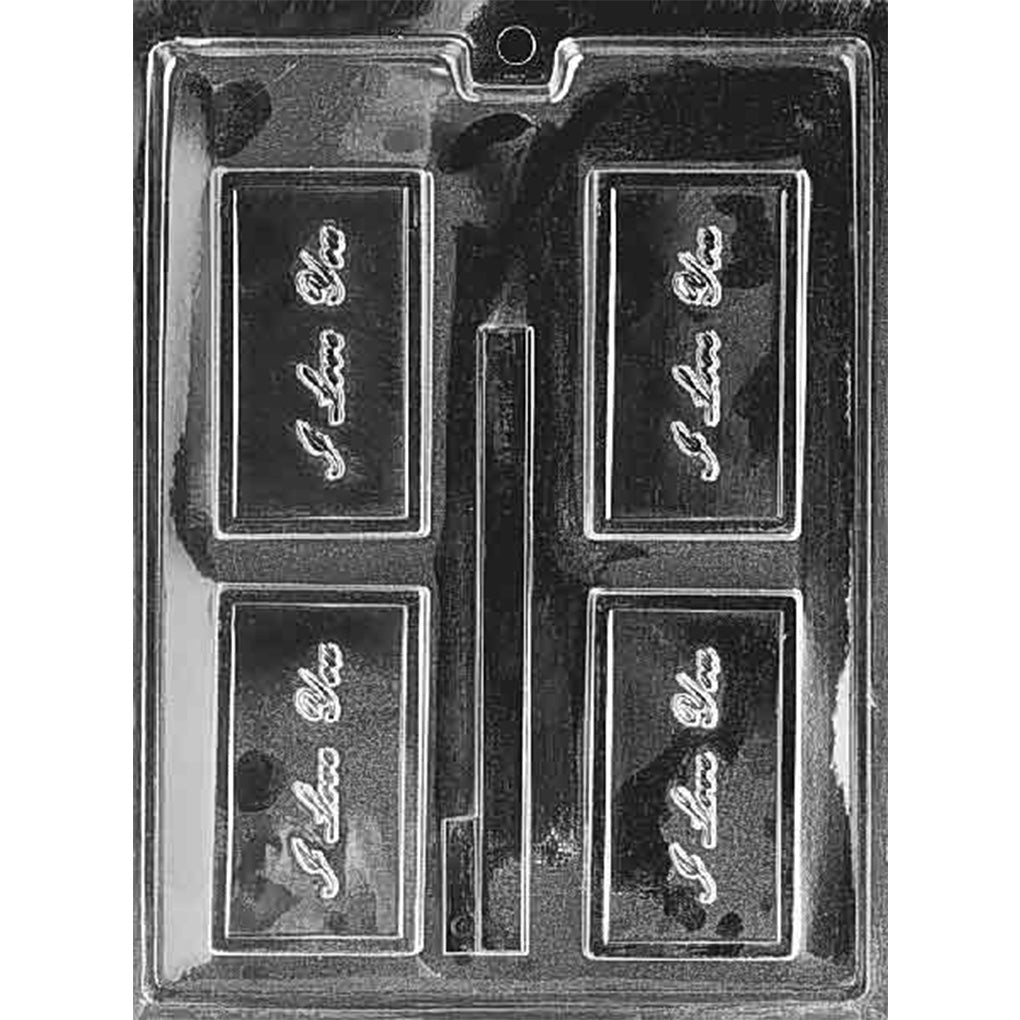 Clear plastic chocolate mold with four rectangular bar cavities featuring raised cursive “I Love You” lettering inside a border, plus a long narrow strip cavity in the center.