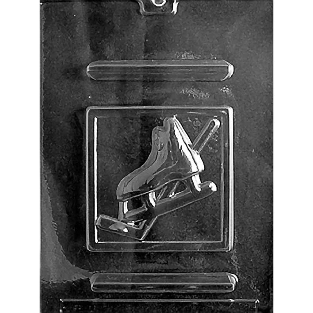 Clear chocolate mold with one square plaque cavity featuring a raised ice hockey skate and hockey stick on a dark background.