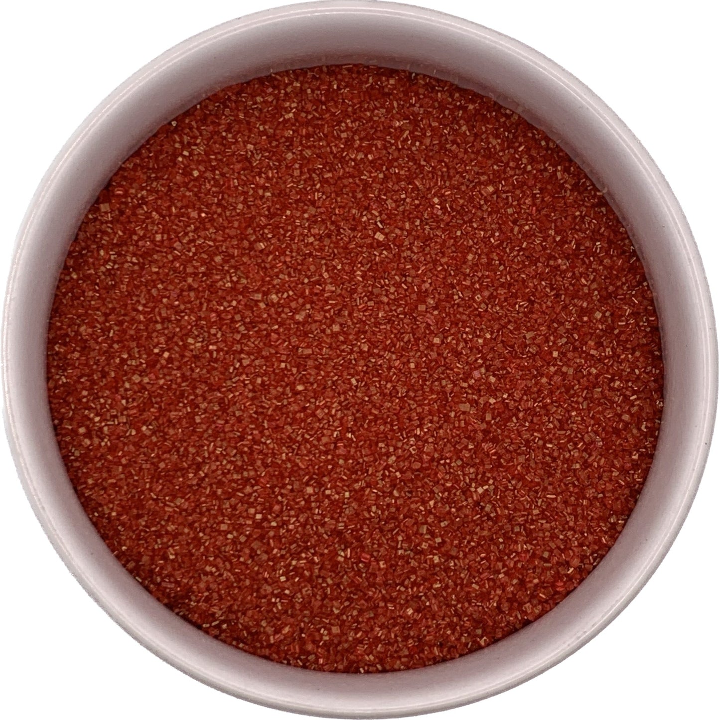 Red sanding sugar close-up in a clear container, vibrant ruby crystals great for holiday and Valentine bakes.