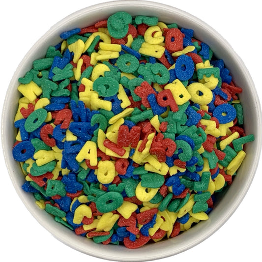 Various Alphabet Shaped Sprinkles in a White Bowl