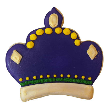 A decorated crown-shaped sugar cookie with deep purple icing, gold accents, and green detailing, resembling a regal, jewel-studded crown.