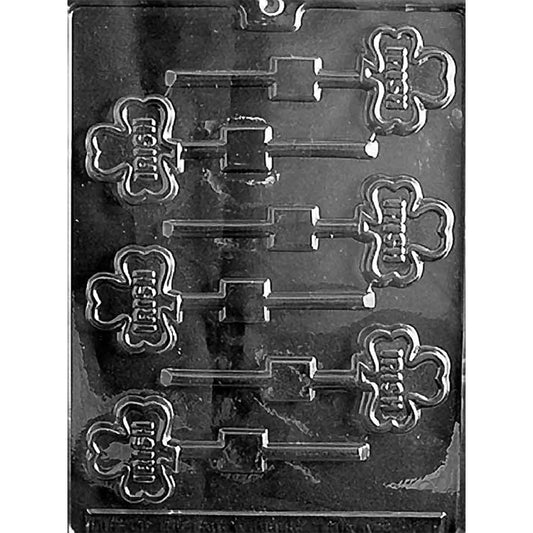 Irish shamrock chocolate lollipop mold with six shamrock-shaped cavities embossed with the word “Irish,” each with a lollipop stick channel, shown in clear plastic.