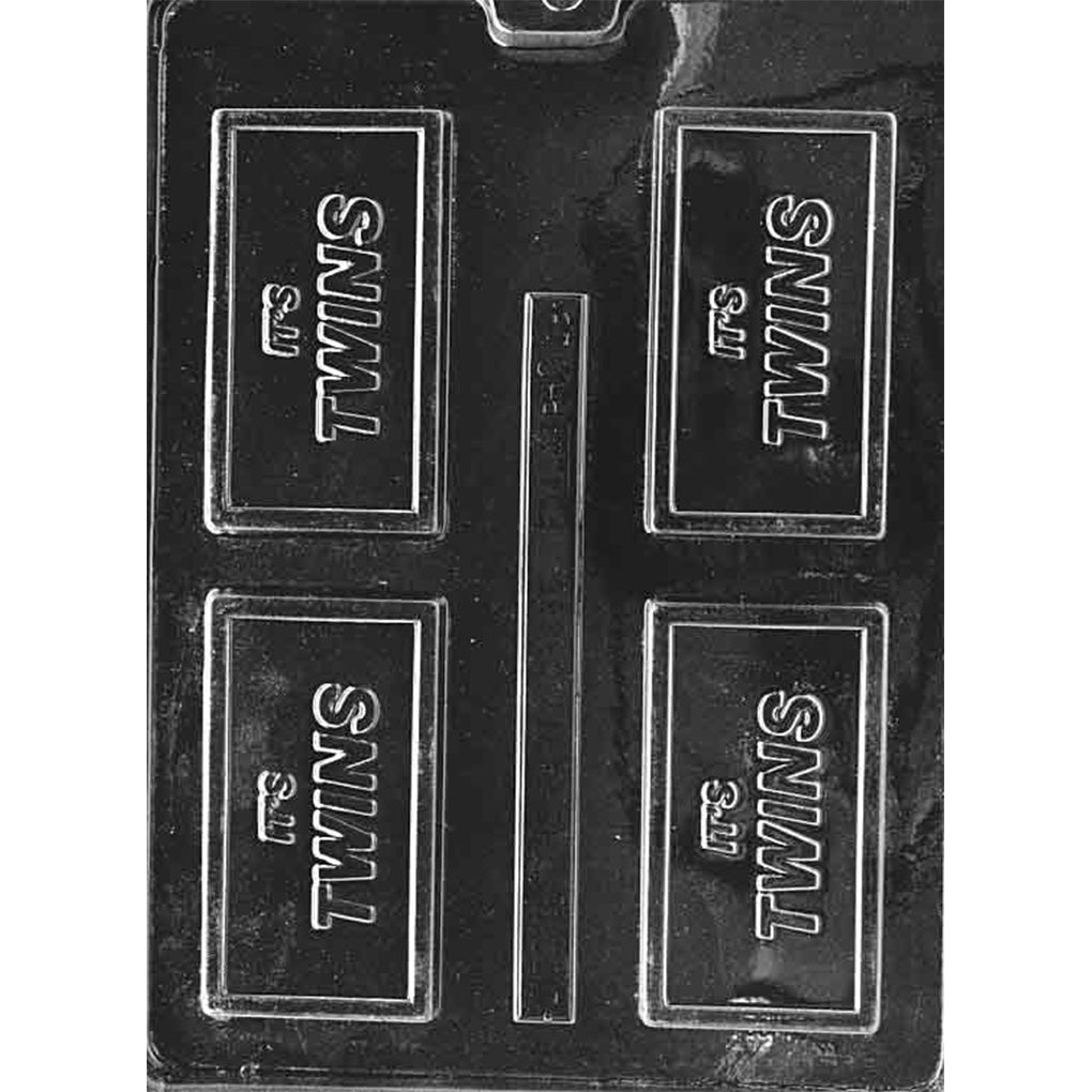 Clear plastic chocolate bar mold with four rectangular cavities, each featuring raised “It’s TWINS” lettering inside a thin rectangular border on a dark background.