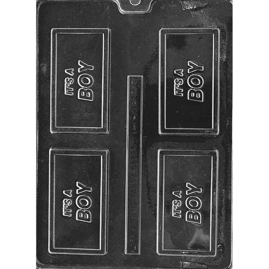 Clear plastic chocolate mold with four rectangular cavities featuring raised “IT’S A BOY” lettering, shown on a dark background.
