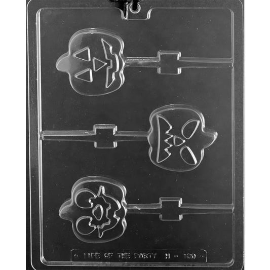 Clear plastic pumpkin face chocolate lollipop mold photographed on a dark background, showing three jack-o'-lantern pop cavities with different carved face expressions and built-in stick channels.