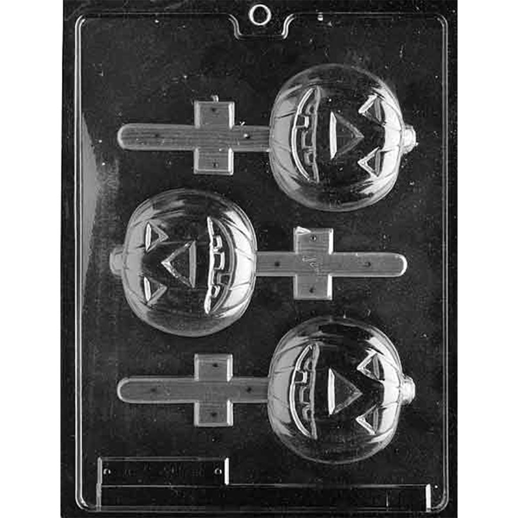 Clear plastic chocolate lollipop mold with three round jack-o-lantern pumpkin cavities featuring raised ridges, triangular eyes, carved smiles, and stick channels.