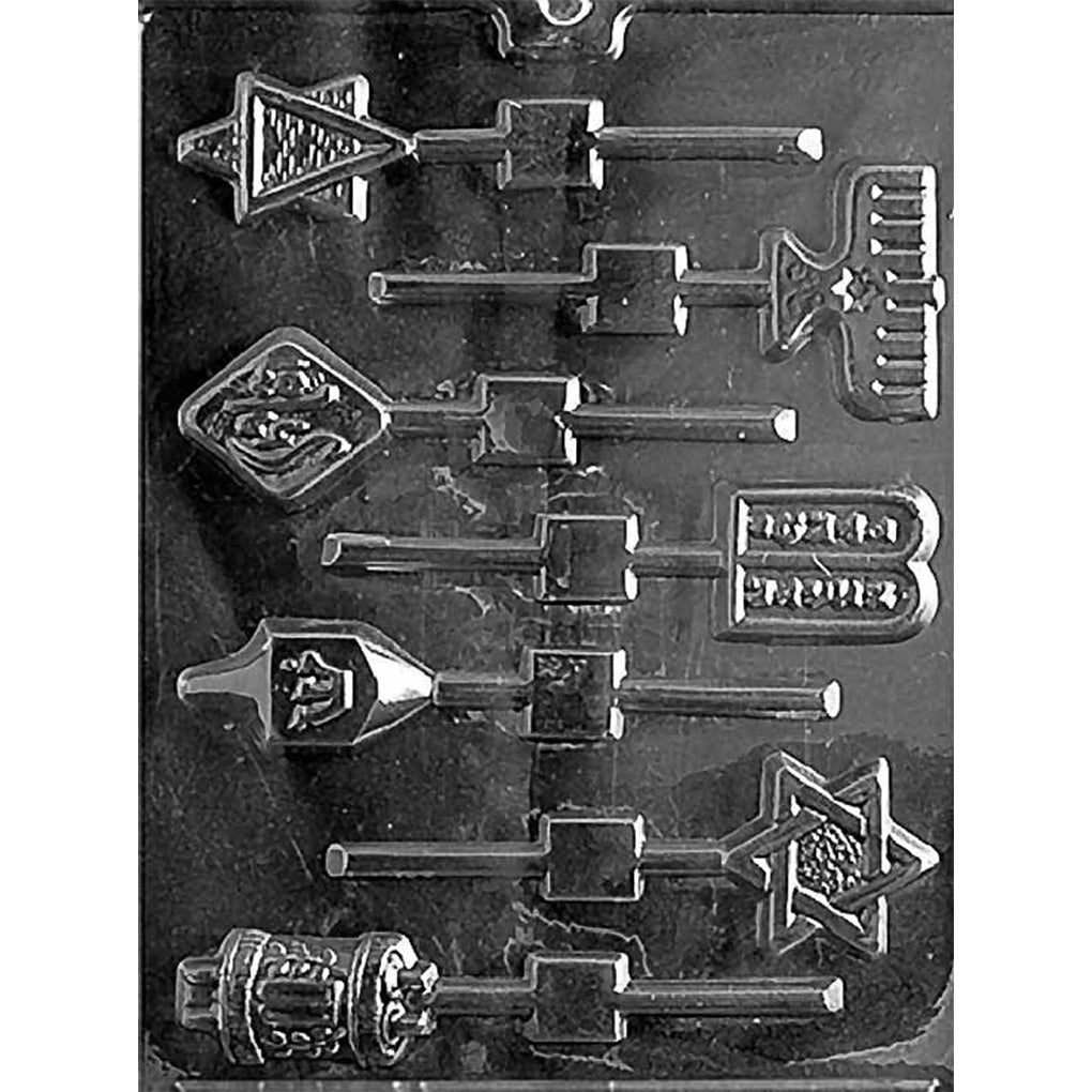 Clear plastic chocolate lollipop mold with assorted Jewish symbol cavities, including a menorah, 10 Commandments tablets, dreidel, Star of David, Torah scroll, and a “shalom” diamond, each with stick channels.