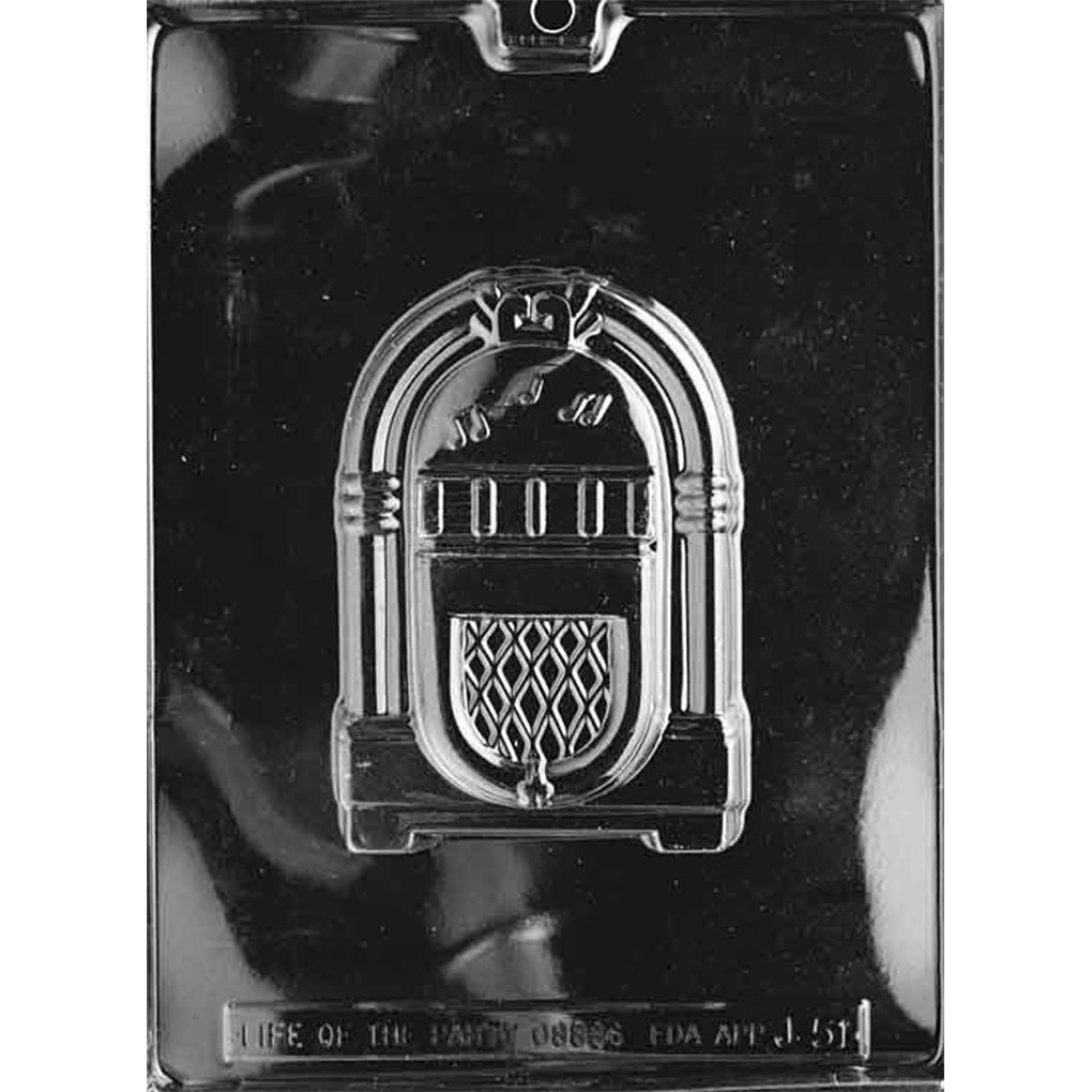 Clear plastic chocolate mold photographed on a black background with one large juke box-shaped cavity featuring arched trim, button details, and a patterned speaker panel.