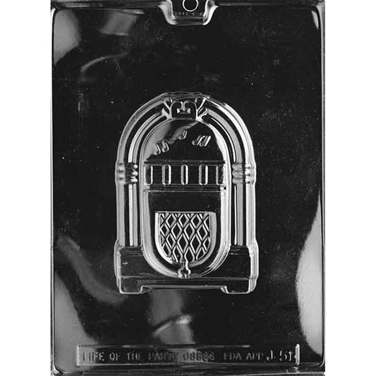 Clear plastic chocolate mold photographed on a black background with one large juke box-shaped cavity featuring arched trim, button details, and a patterned speaker panel.