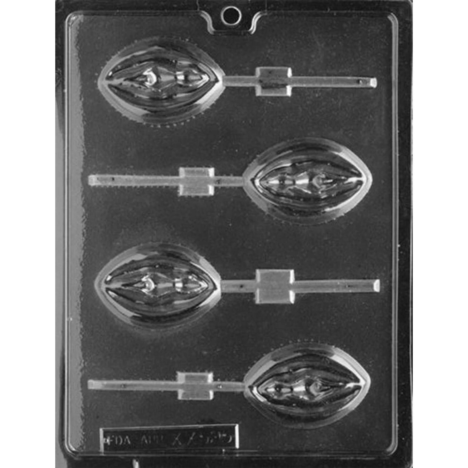 Clear plastic adult chocolate lollipop mold photographed against a black background with four oval cavities featuring sculpted vulva designs and built-in lollipop stick channels.
