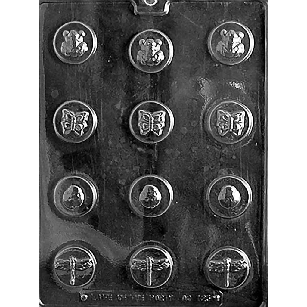Clear plastic chocolate mold photographed on a dark background with twelve small round cavities, each embossed with a ladybug, butterfly, or dragonfly design arranged in rows.