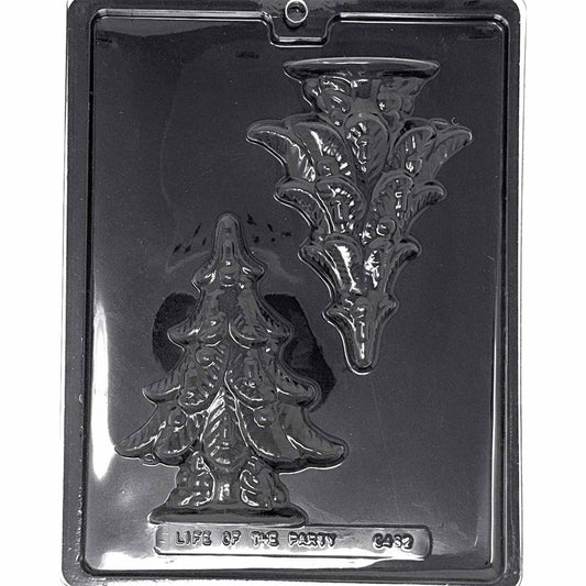 Clear Large Christmas Tree Chocolate Mold photographed against a black background with one detailed tree cavity featuring layered branches and molded holiday decorations.