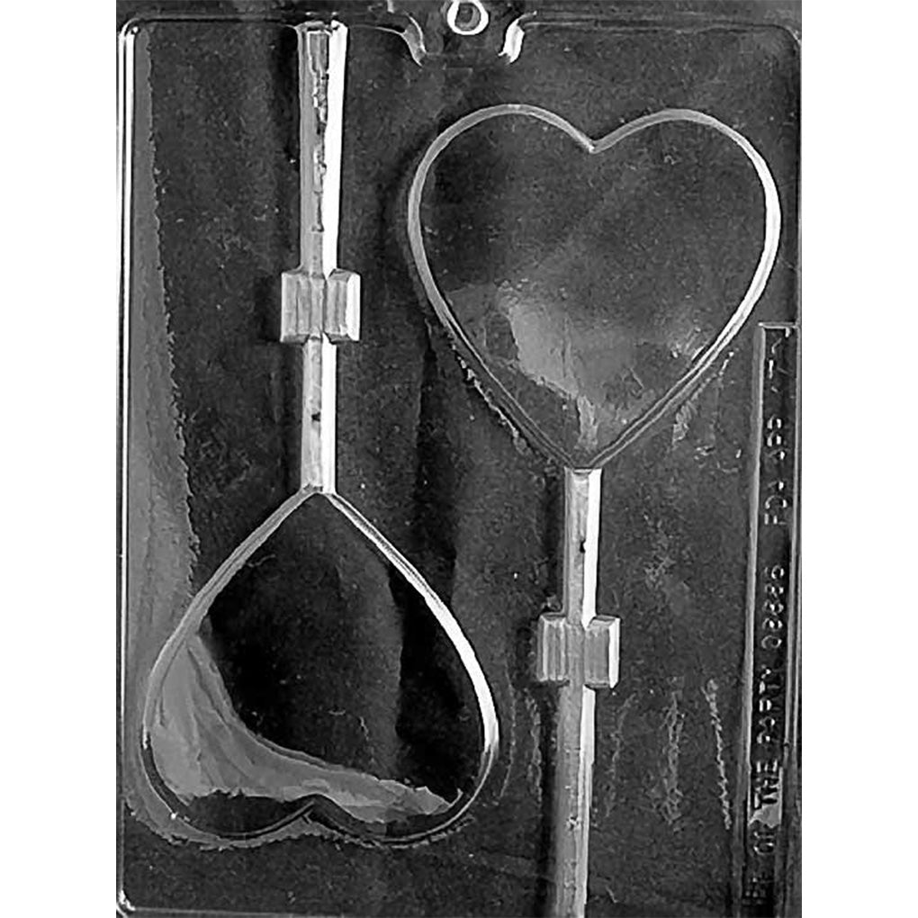 Clear chocolate lollipop mold with two large smooth heart-shaped cavities and straight stick channels on a dark background.