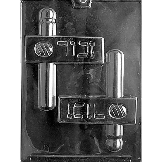Clear plastic chocolate mold with two large gragger noisemaker cavities, each showing a long handle and a rectangular body with raised lettering and a striped circle detail.